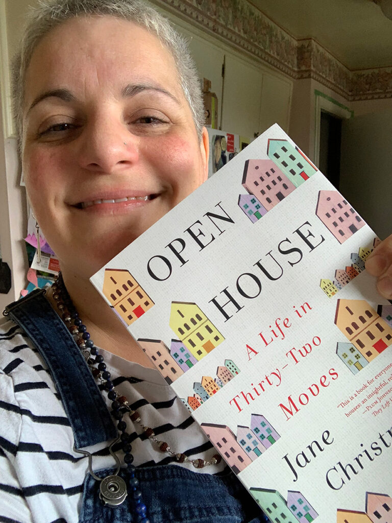 Photo of Vanessa Shields, author and friend of Jane Christmas, holding a copy of Jane's new memoir Open House